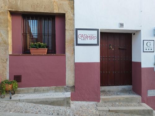 a building with two doors and a sign on it at Casimiro Alojamiento Rural in Guadalupe