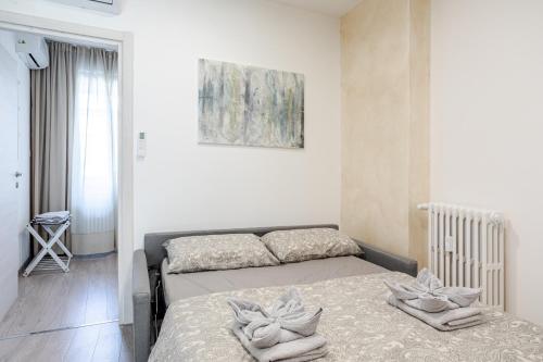 a bedroom with two beds and a painting on the wall at Teatro Romano Suites - Francesca in Trieste