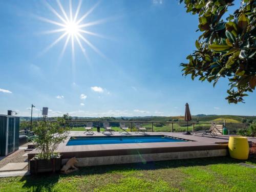 a swimming pool with the sun in the sky at Helix 1912 in Bric Gallo