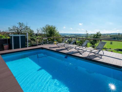 a swimming pool with chairs and a deck with a view at Helix 1912 in Bric Gallo