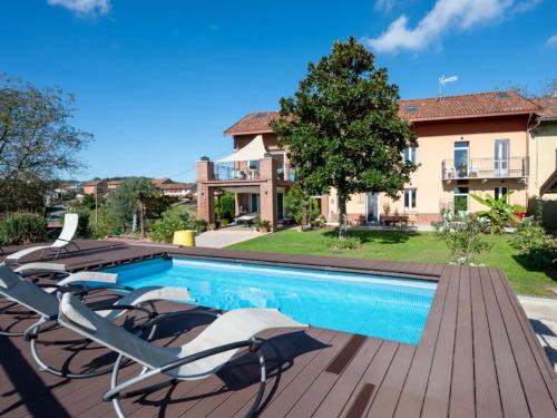 a swimming pool with lounge chairs next to a house at Helix 1912 in Bric Gallo