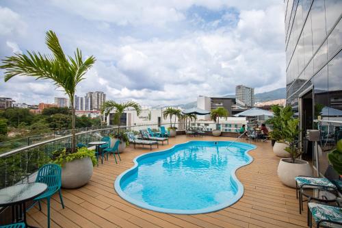 a balcony with a swimming pool on top of a building at Hotel Roseliere Bucaramanga in Bucaramanga