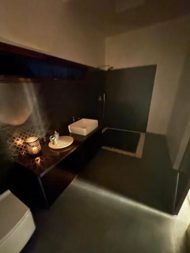 a small bathroom with a sink and a toilet at Mavu Days in Hongashenhalli