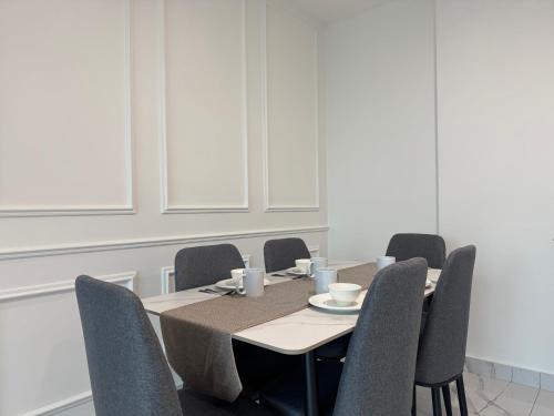 a dining room with a table and chairs at Alfa Bangsar By Fwd Host in Kuala Lumpur