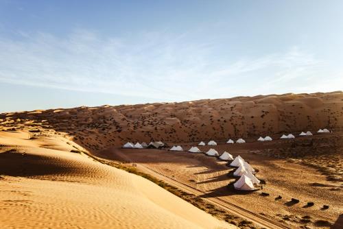 a desert view of a building in the sand at Magic Camp Wahiba Sands in Bidiyah