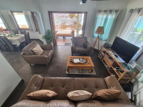 a living room with a couch and a table at Marquise & Infinity villas in Glacis