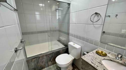 a bathroom with a toilet and a sink and a shower at Renoir - Av Barão Homem de Melo nº 4520 - pegar nº do flat no chat após reserva in Belo Horizonte