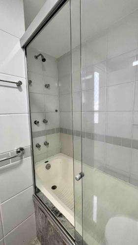 a glass shower in a bathroom with a sink at Renoir - Av Barão Homem de Melo nº 4520 - pegar nº do flat no chat após reserva in Belo Horizonte