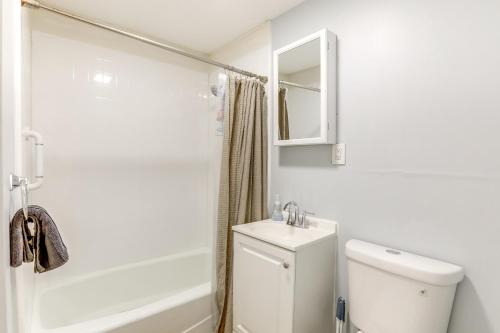 a white bathroom with a toilet and a sink at 3 Mi to Dtwn Home with Yard in Newark in Newark