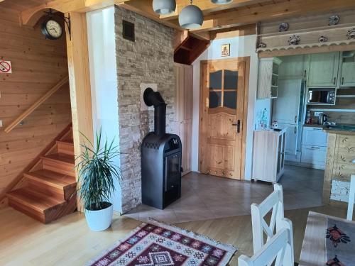 a living room with a wood stove in a house at Domek Wypoczynkowy Relax in Bystra