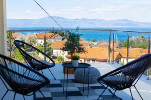 a balcony with chairs and a table with a view at Luxury apartments Vanessa, Njivice in Njivice