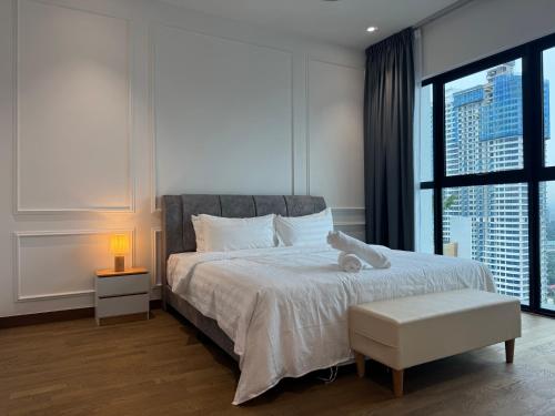 a bedroom with a bed with a teddy bear on it at Alfa Bangsar By Fwd Host in Kuala Lumpur