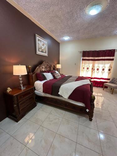 a bedroom with a large bed and a window at Hidden Gem Emerald in Buff Bay Portland in Cascade