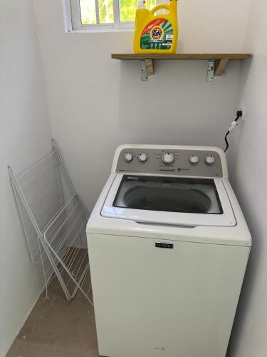a white stove in a kitchen with a window at Hidden Gem Emerald in Buff Bay Portland in Cascade