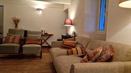 a living room with a couch and two chairs at Monte do Balharico by Portus Alacer in Avis