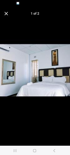 a bedroom with a large bed with white sheets at 27 on Milton in Cape Town