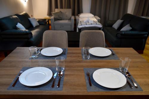 a wooden table with plates and utensils on it at Wooden Attic in Kastoria
