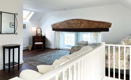 a living room with a couch and a window at Number Three The Old Drill Hall in Sturminster Newton