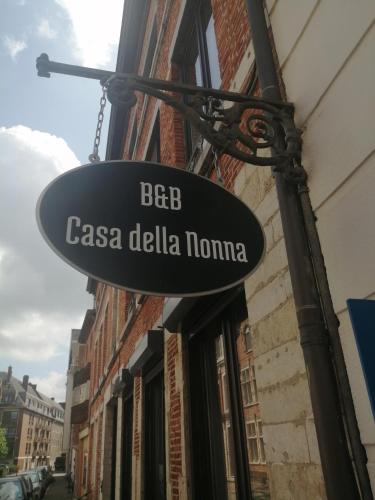 a sign hanging from the side of a building at Casa della Nonna in Diest