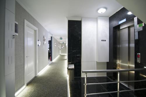 a hallway with black and white walls and a hallway with doors at Hill Life Hotel in Lüleburgaz