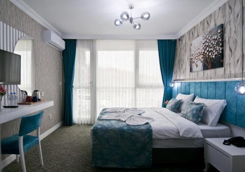a hotel room with a bed with a blue wall at Hill Life Hotel in Lüleburgaz