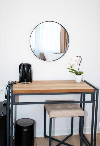 a table with a mirror and a stool at Орбелус in Bansko