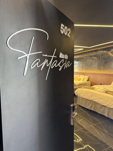 a sign for a hotel room with two beds at HOTEL NOVO CENTRO in Petrolina