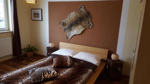 a bedroom with a bed with a leopard print headboard at Hotel Rosenhof in Isenbüttel