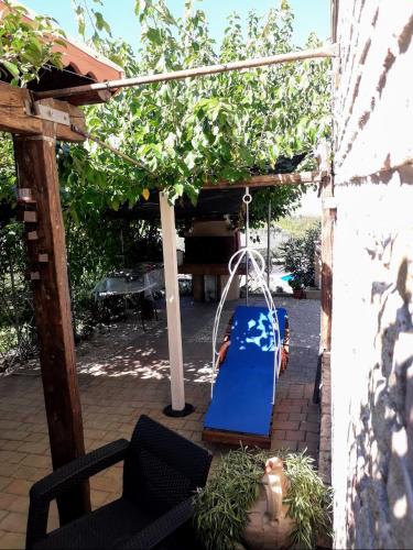a playground with a blue slide in a pergola at Casa Silos in Arcevia