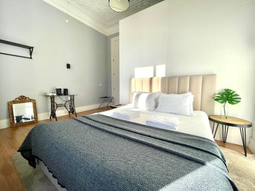 a bedroom with a large bed and a mirror at Lisbon Check-In Guesthouse in Lisbon
