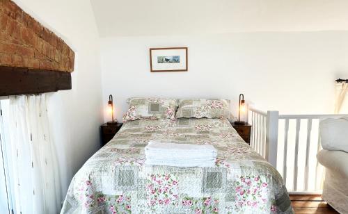 a bedroom with a bed with a quilt on it at Number Three The Old Drill Hall in Sturminster Newton