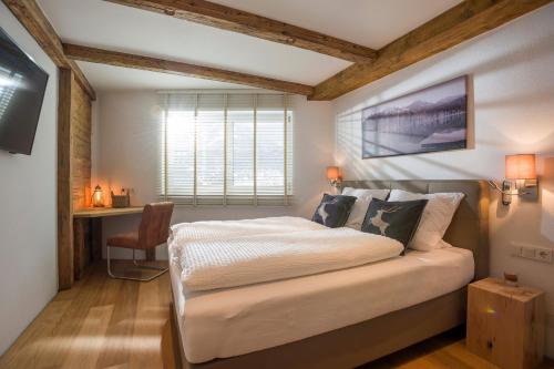 - une chambre avec un lit et un bureau dans l'établissement Luxus Ferienwohnung Almhütte, à Brixen im Thale