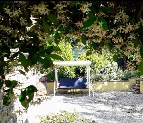 a swing in a garden under a white canopy at Casa Silos in Arcevia