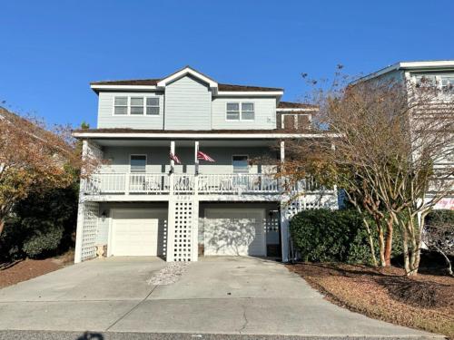 a white house with a balcony and a driveway at CW03 Starfish Serenade in Nags Head