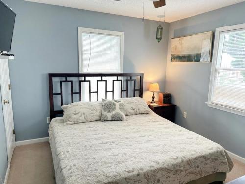 a bedroom with a bed with a white bedspread and two pillows at CW03 Starfish Serenade in Nags Head
