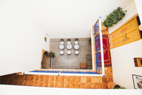 a kitchen with a shower with a tile wall at Riad Dar Kella in Marrakech