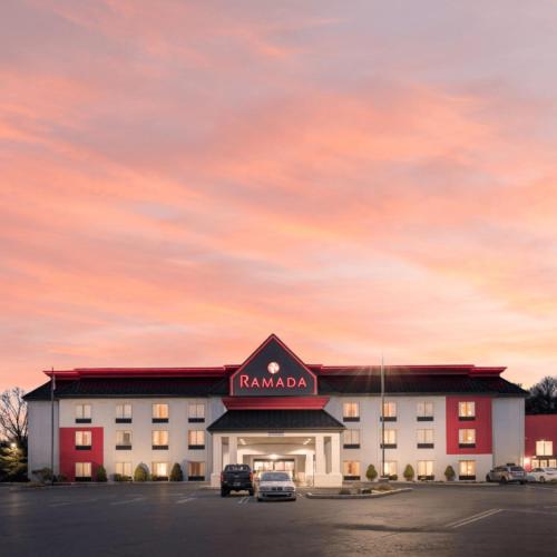 a hotel with a parking lot in front of a building at Ramada by Wyndham Harrisburg/Hershey Area in Harrisburg