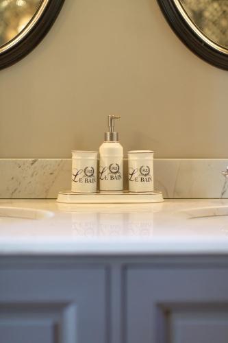 - un comptoir de salle de bains avec trois distributeurs de savon dans l'établissement Villa Madeleine en 1ère ligne pour 17 personnes, à Lège-Cap-Ferret