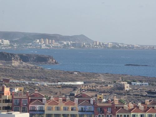 a view of a city with houses and the ocean at CasaMaria in Playa Paraiso