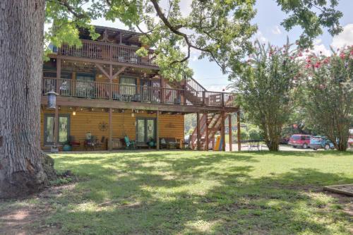 a log home with a deck and a yard at 3 Mi to Great Smoky Mtn NP Riverfront Retreat in Townsend