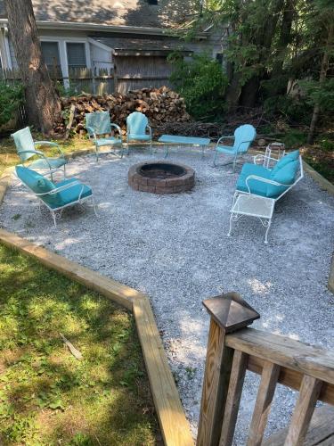 a group of chairs sitting around a fire pit at In Union Pier! By Beach with 5 bedrooms, jacuzzi, yard in Union Pier