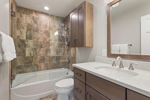 a bathroom with a tub and a toilet and a sink at Villa's of Aspen by Snowmass Vacations in Aspen