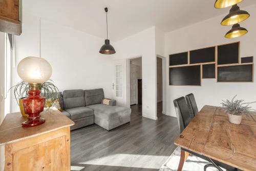 a living room with a couch and a table at Casa da Estação in Caldas da Rainha
