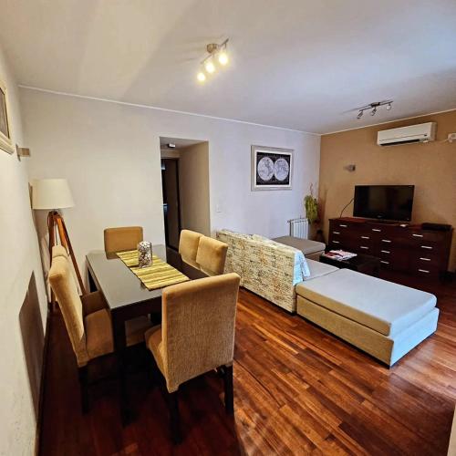 a living room with a bed and a table and a couch at Apart Santa Marta in Salta