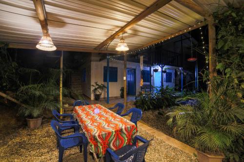 a patio with a table and chairs and lights at La Posada de las Aves in San Rafael