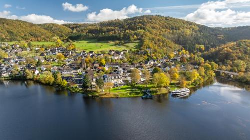 an aerial view of a small town on a lake at Garni Hotel im Fachwerkhof in Simmerath