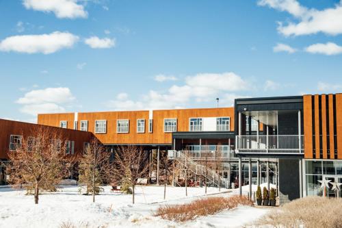 a building in the snow with a building at Hôtel & Spa Le Germain Charlevoix in Baie-Saint-Paul