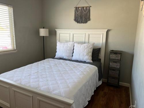 a bedroom with a bed with white sheets and pillows at Cozy House in Fallon- 3BedRoom, 2BathRooms in Fallon
