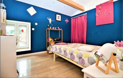 a childs bedroom with blue walls and a bed at Maison de Village 4 chambres in Sabran