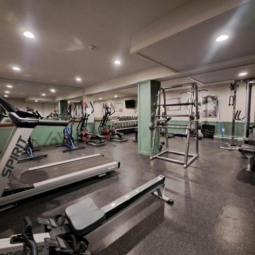 a gym with several treadmills and machines in it at Riverbend Townhomes by StayIn in Panorama